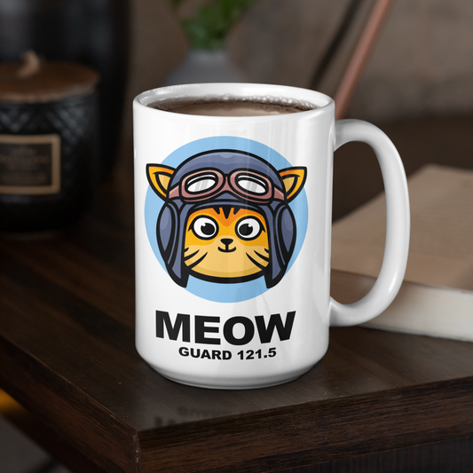 White mug with a cute cartoon cat and text reading Meow Gaurd 121.5 sitting on a dark wood table