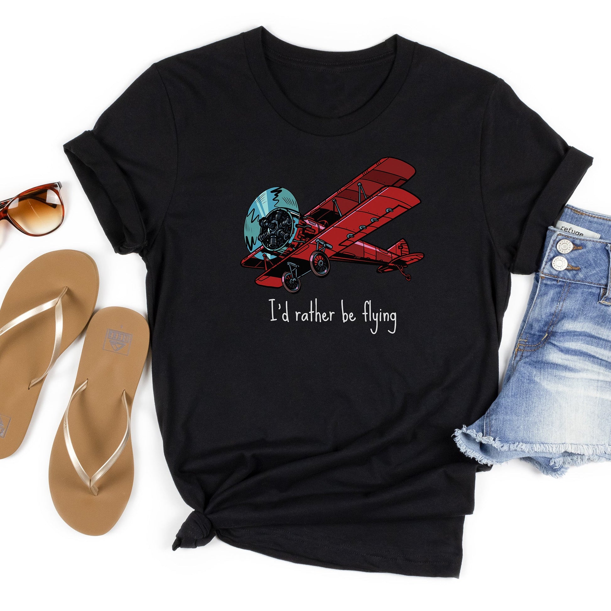 Black t-shirt flatlay with a large red biplane and text stating I'd rather be flying underneath