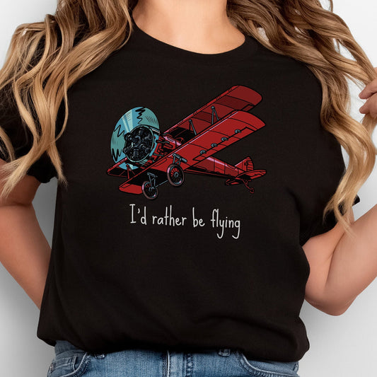 Woman wearing a t-shirt in black with a large red biplane and text stating I'd rather be flying underneath