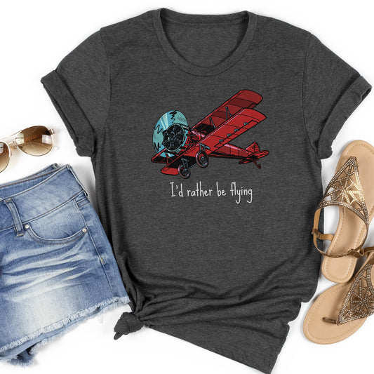 Dark gray t-shirt flatlay with a large red biplane and text stating I'd rather be flying underneath