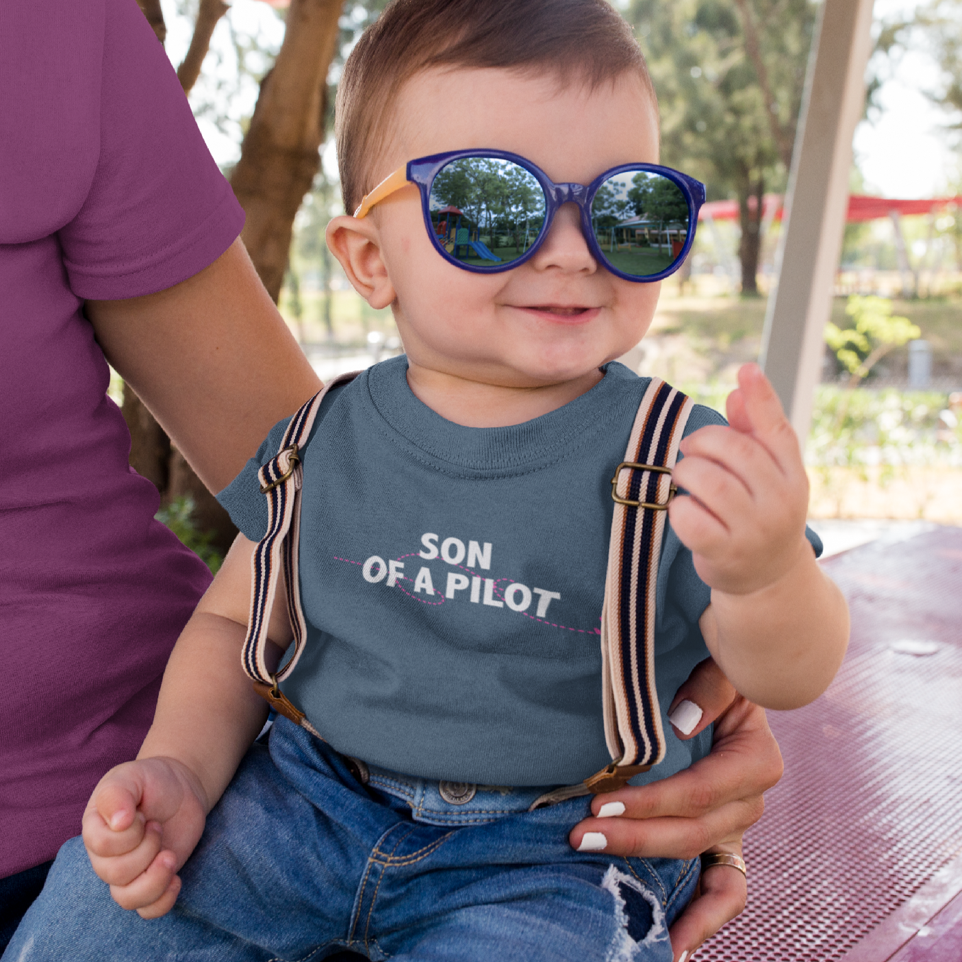 Small child with Son of a Pilot t-shirt and suspenders